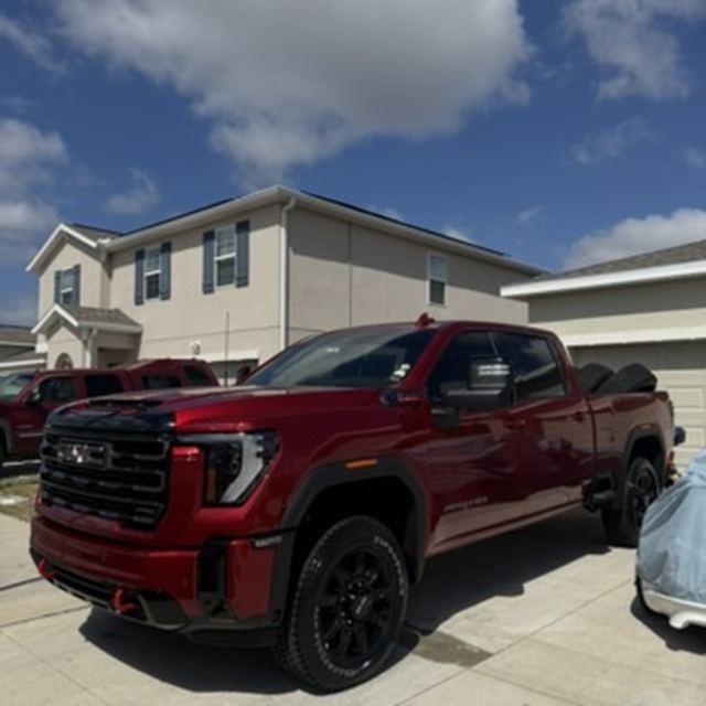 Ceramic window tint on a red GMC Sierra pickup truck — mobile tint job in Kissimmee, FL